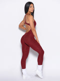 right side profile view of our model wearing the Athletic Bodysuit in Black Cherry color