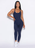 Front profile view of our model with one hand on her waist wearing the Athletic Bodysuit in Cosmic Blue color