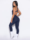 left side profile view of our model wearing the Athletic Bodysuit in Cosmic Blue color