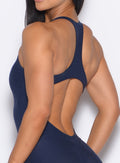 Close up back profile shot of our model wearing the Athletic Bodysuit in Cosmic Blue color