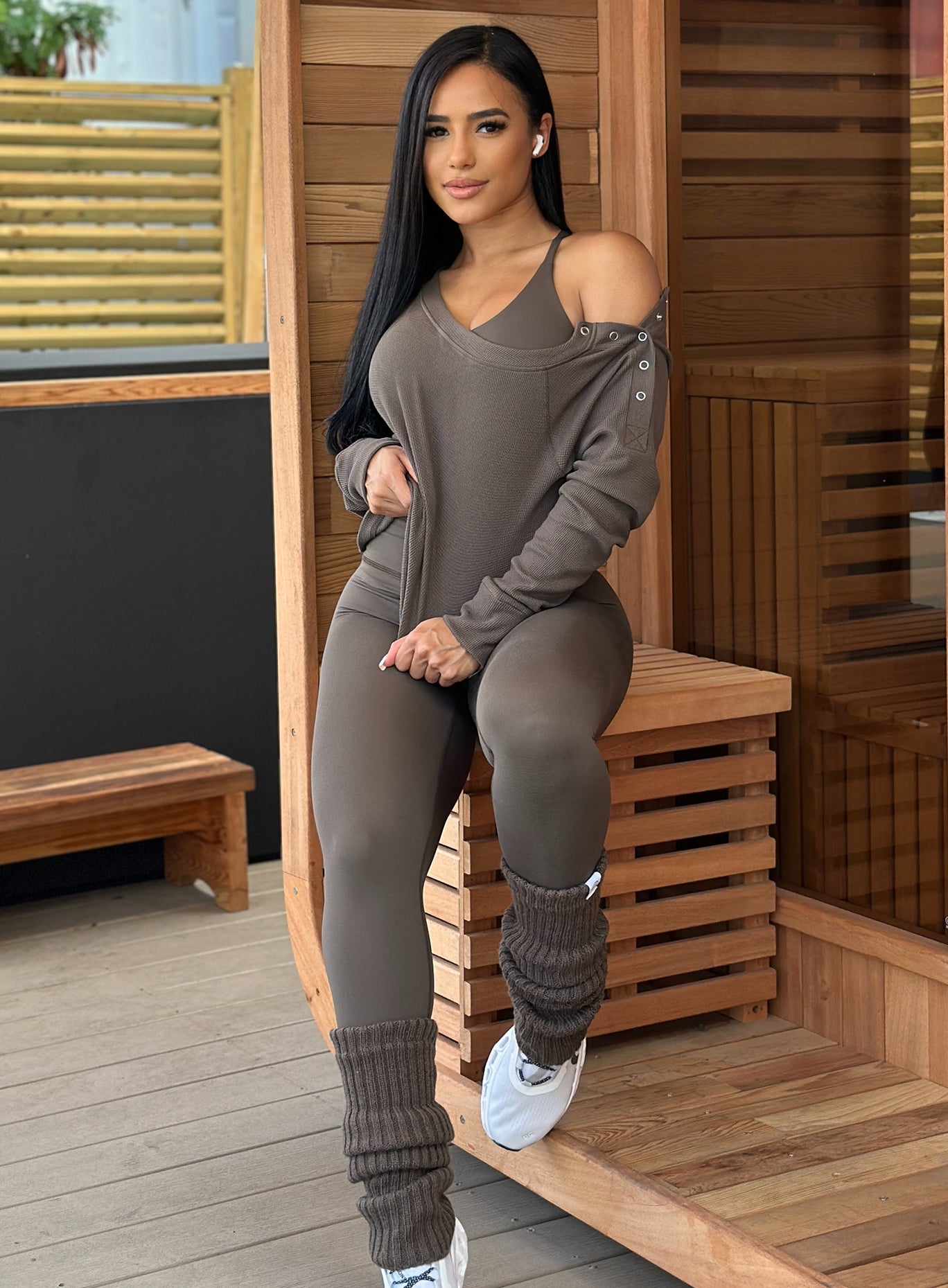 front profile view of a model in outdoors wearing the Luxe Leg Warmers in Winter oak color