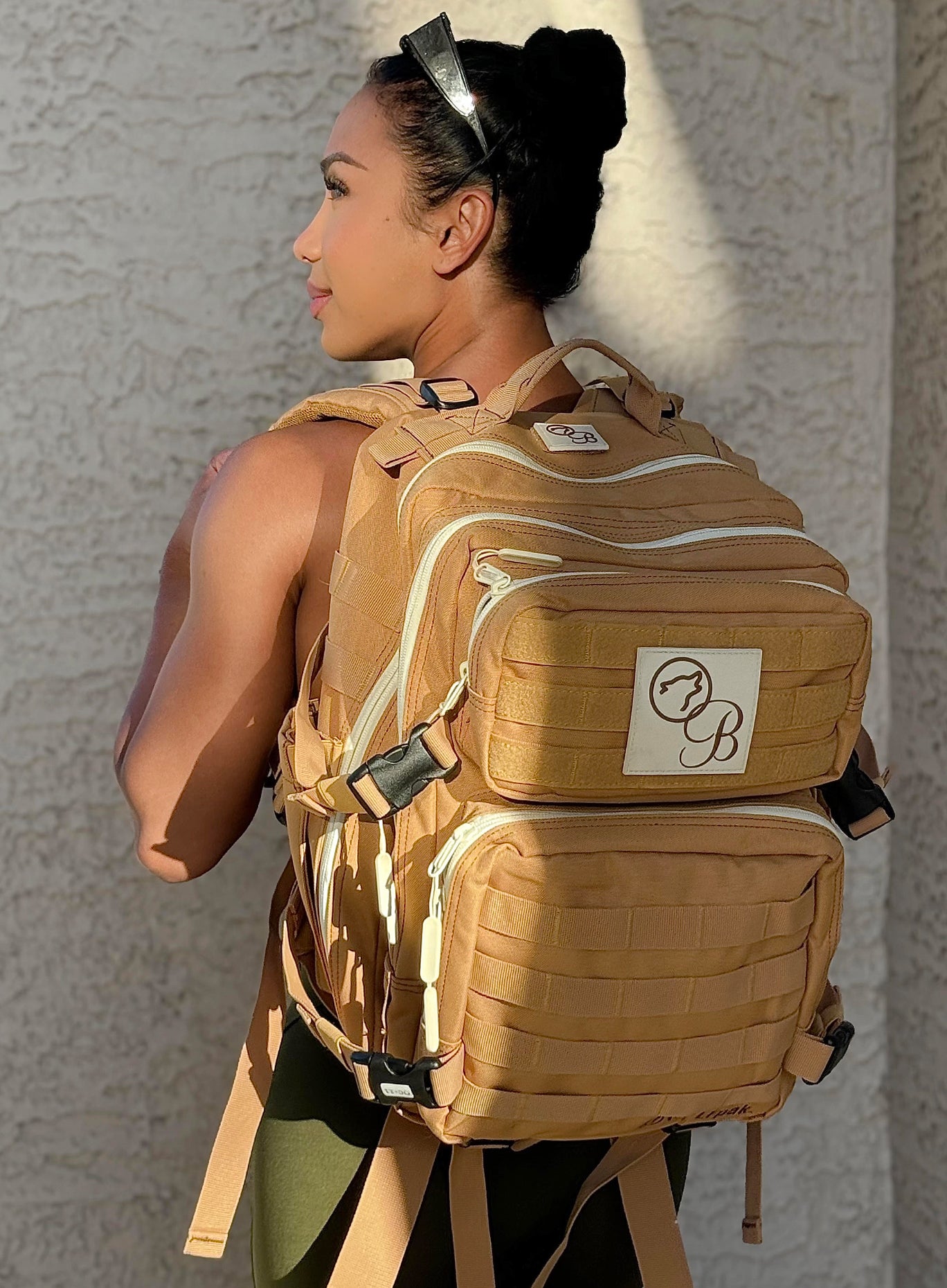 back view of model with the bombshell, wolfpak backpack in the color caramel