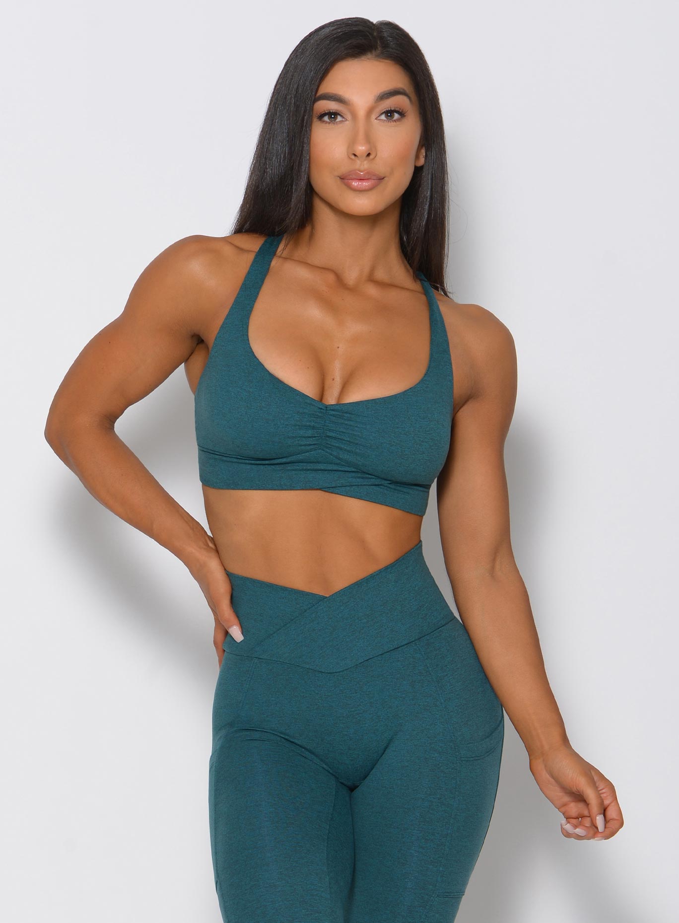 model in teal angel bra facing front arm on hip