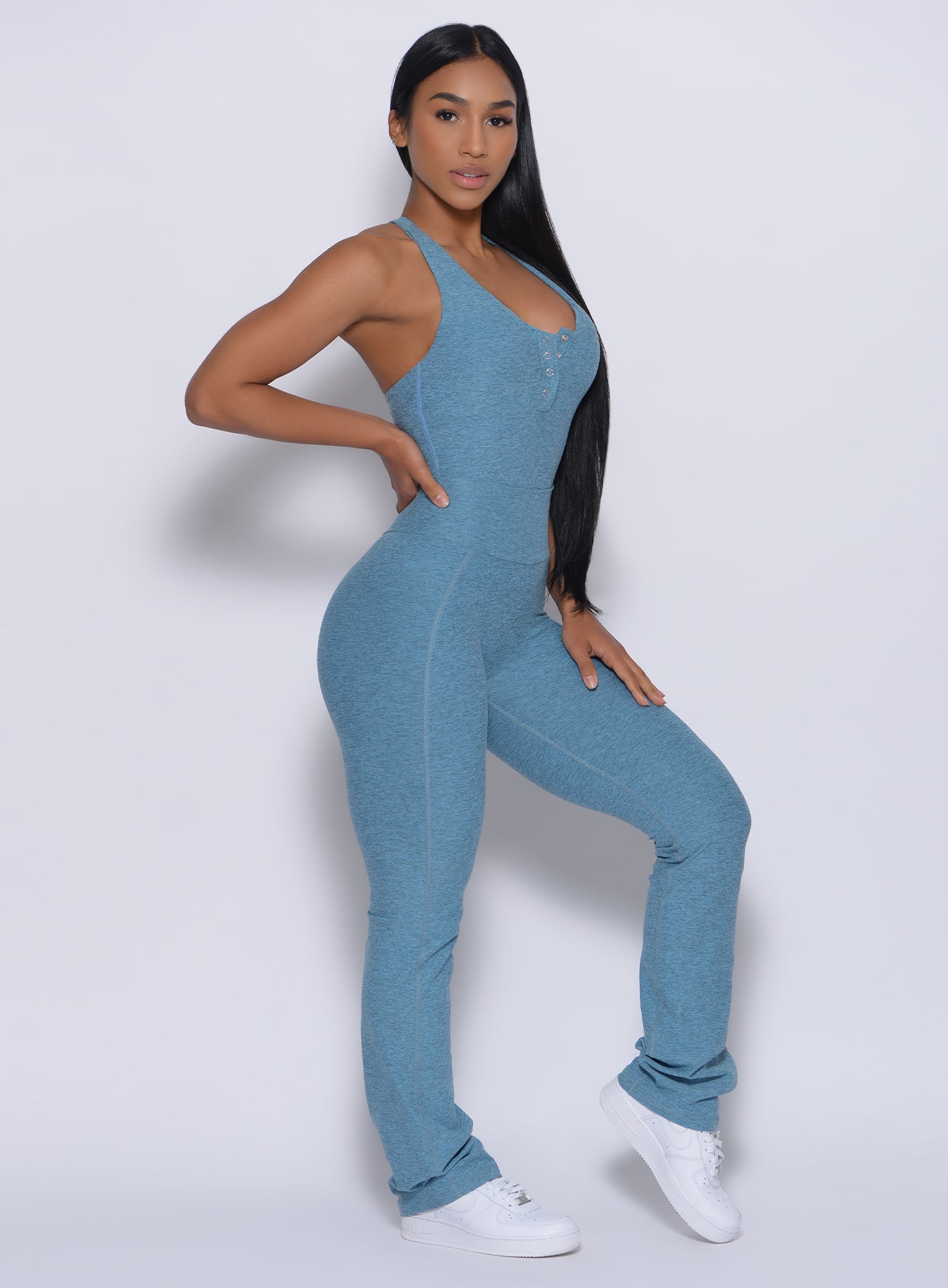 Right side profile view of a model in our straight up leggings in baby blue color and a matching bodysuit