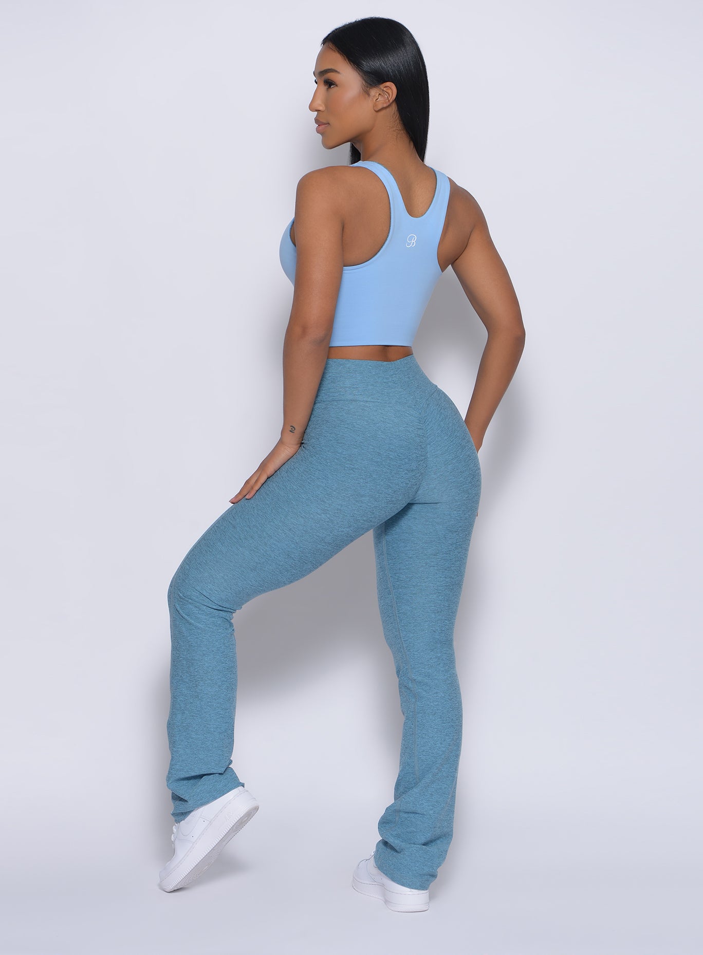 Left side profile view of a model wearing our straight up leggings in baby blue color and a matching top