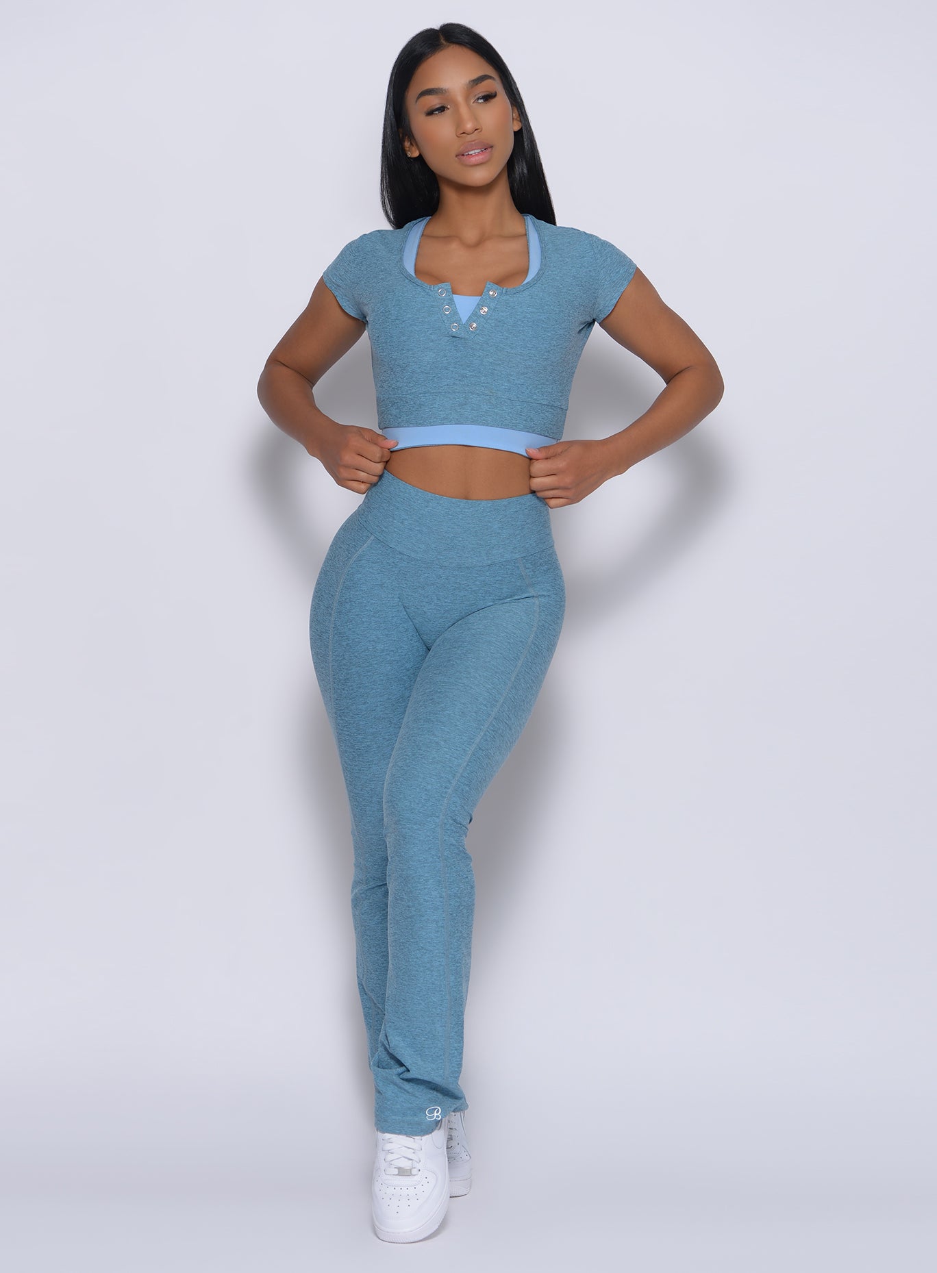 Front profile view of a model in our straight up leggings in baby blue color and a matching bra