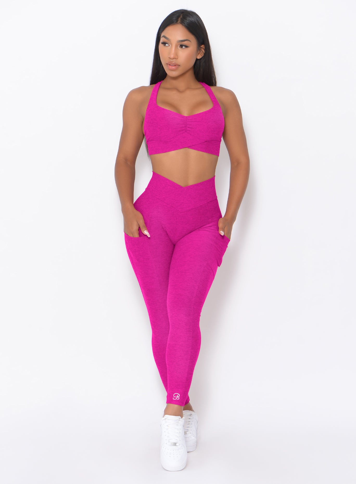 front profile view of a model wearing our Contour Leggings in Ultra Pink color and a matching bra