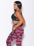 Left side profile view of a model in our black back it up bra and a purple camo joggers