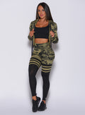 Front profile view of a model in our green camo scrunch thigh high and a matching bra along with a camo pullover 