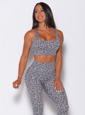 Front profile view of the model wearing our cheetah racerback bra in lightning gray color and a matching leggings