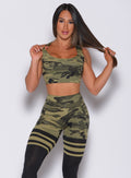 Front profile view of a model in our green camo reversible tank bra and a matching leggings 