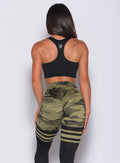 back profile view of a model in our green camo reversible tank bra and a matching leggings