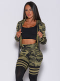 Front profile view of a model in our bright army camo signature jacket and a matching thigh high leggings 