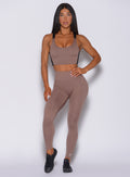 Front profile view of the model wearing our snatched waist leggings in cocoa color and a matching bra