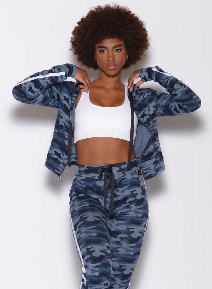 Front profile view of a model in our dream jacket in Blue Blast Camo color and a matching joggers 