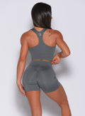 Back profile view of a model wearing our ultimate tank bra in steel gray color and a matching shorts 