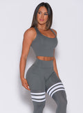 Right side profile view of a model angled right wearing our ultimate tank bra in steel gray color and a matching leggings