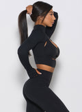 Right side profile view of the model wearing the black pullover 